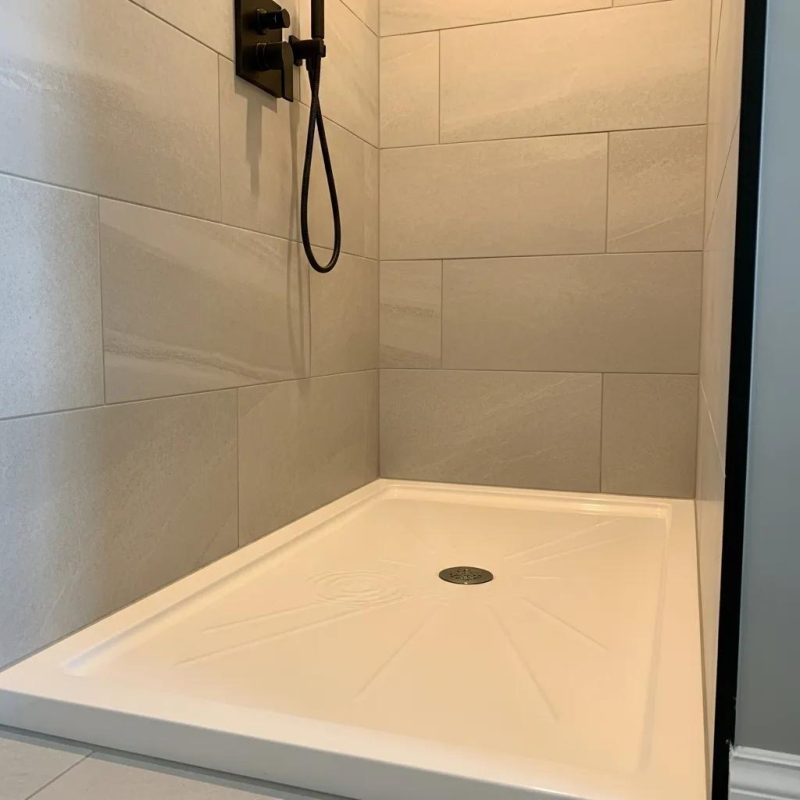 Refinished shower base in a modern bathroom highlighting its glossy surface and pristine condition